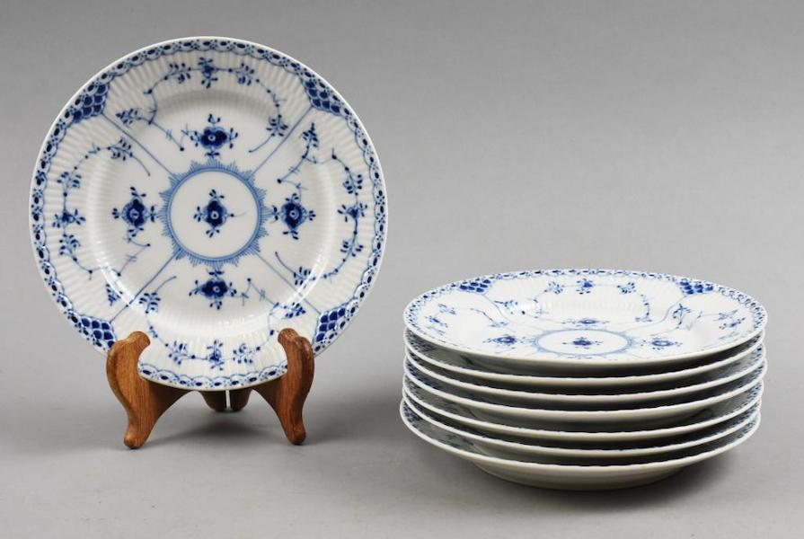Assorted Royal Copenhagen porcelain pieces in the blue fluted Half Lace pattern; pictured are eight salad plates, together estimated at $100-$500