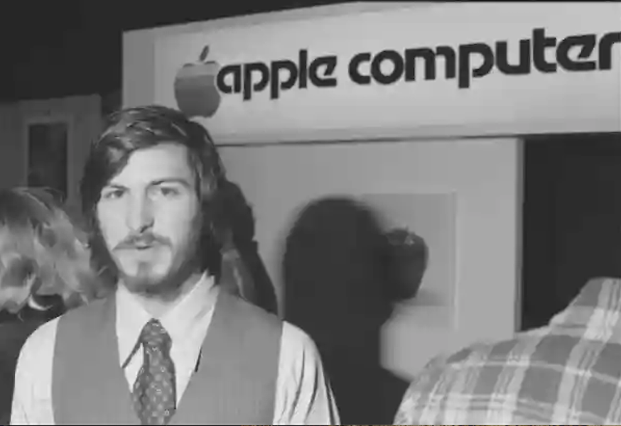 Period photo of Steve Jobs with the Apple Computer trade sign behind him. Image courtesy of Alexander Historical Auctions