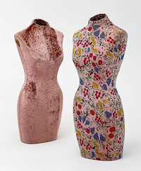 Geoffrey Beene mannequins, set of two, one clad in a plush pink crushed velvet fabric with floral motifs, the other covered in a floral and fruit pattern fabric, estimated at $1,200-$1,800