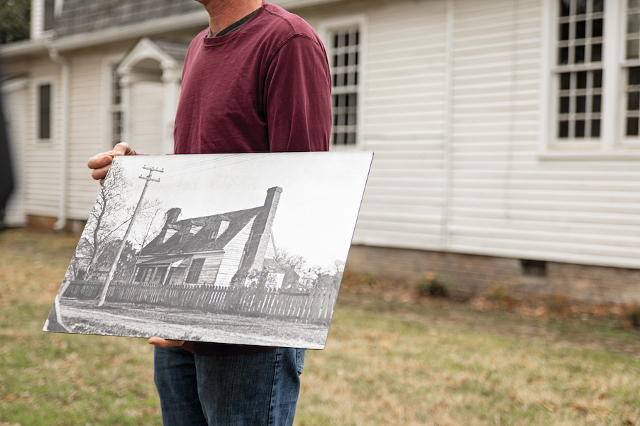 At the Bray School building, Steve Chabra, Colonial Williamsburg architectural preservation program supervisor, displays an archival image of the building, March 17, 2022 Credit: Photo by Brian Newson, The Colonial Williamsburg Foundation