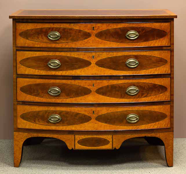 Federal satinwood and mahogany bow-front chest of drawers made in 1812 in Saco, Maine, estimated at $10,000-$15,000