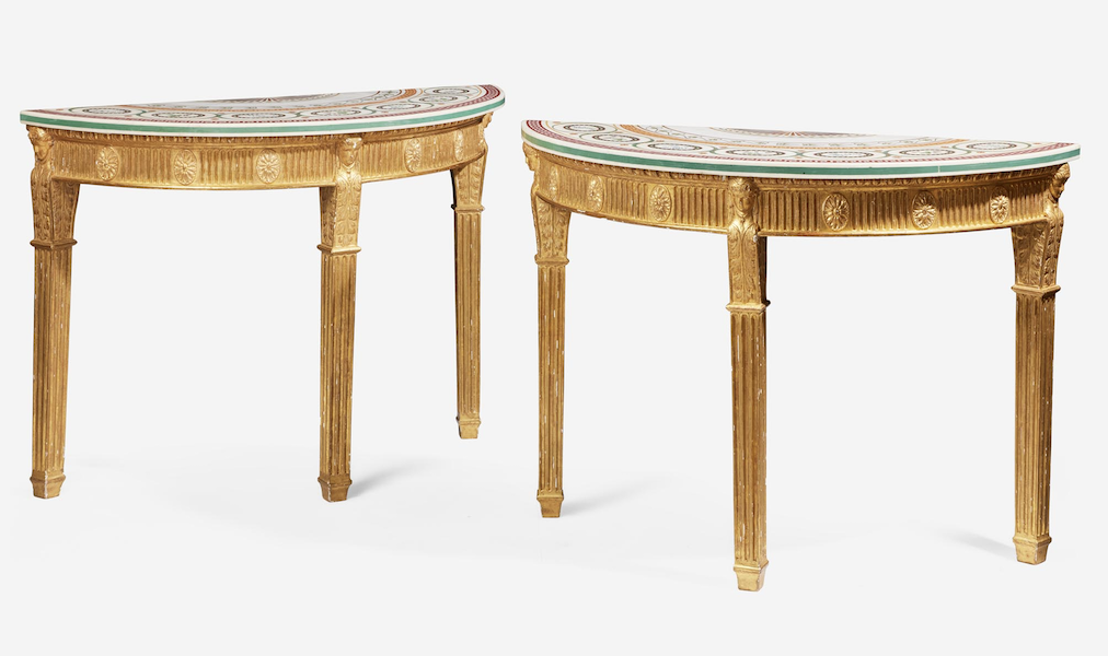 George III scagliola inlaid and giltwood demilune tables, estimated at $20,000-$40,000. Image courtesy of Freeman’s