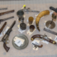 Connecticut State Troopers will escort the rare Colt Whitneyville Walker revolver (visible in the bottom row with CT tag) back to its home state. A powderhorn (center right) dating to the French and Indian War was stolen from a Belchertown, Massachusetts, museum in the 1970s. Both were among dozens of artifacts stolen from several different American museums five decades ago that will soon be returned. Image courtesy of the Federal Bureau of Investigations (FBI)