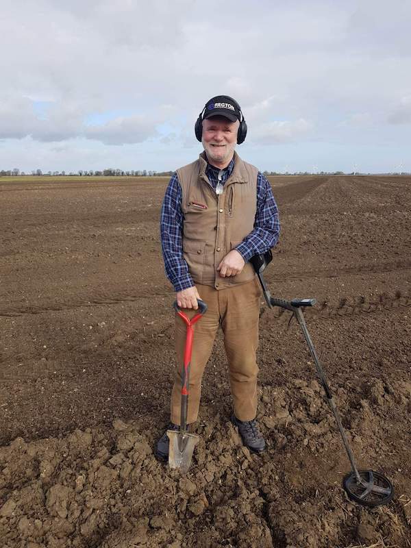 Paul Shepheard, who discovered the Celtic fertility figure in 2022 in a field in Haconby, England, poses with his metal detector and shovel. Image courtesy of Noonans, photo credit Paul Shepheard