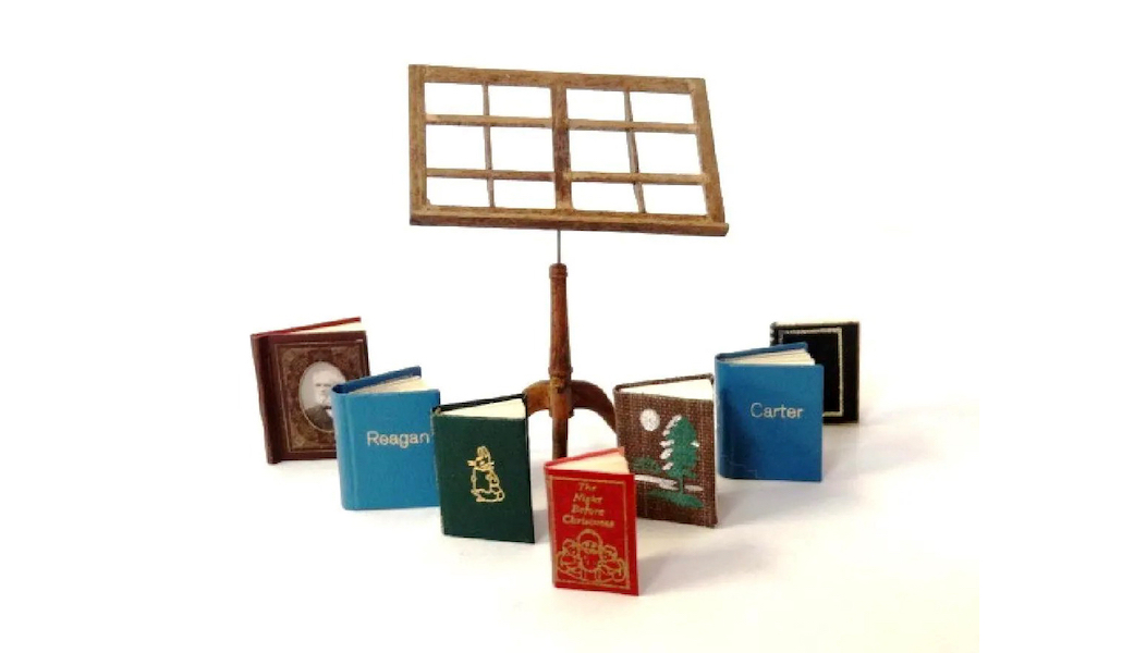 A group of micro-miniature books at dollhouse scale, printed by different artisans and offered with an unsigned mahogany book stand, went for $325 plus the buyer’s premium in April 2019. Image courtesy of Ron Rhoads Auctioneers and LiveAuctioneers