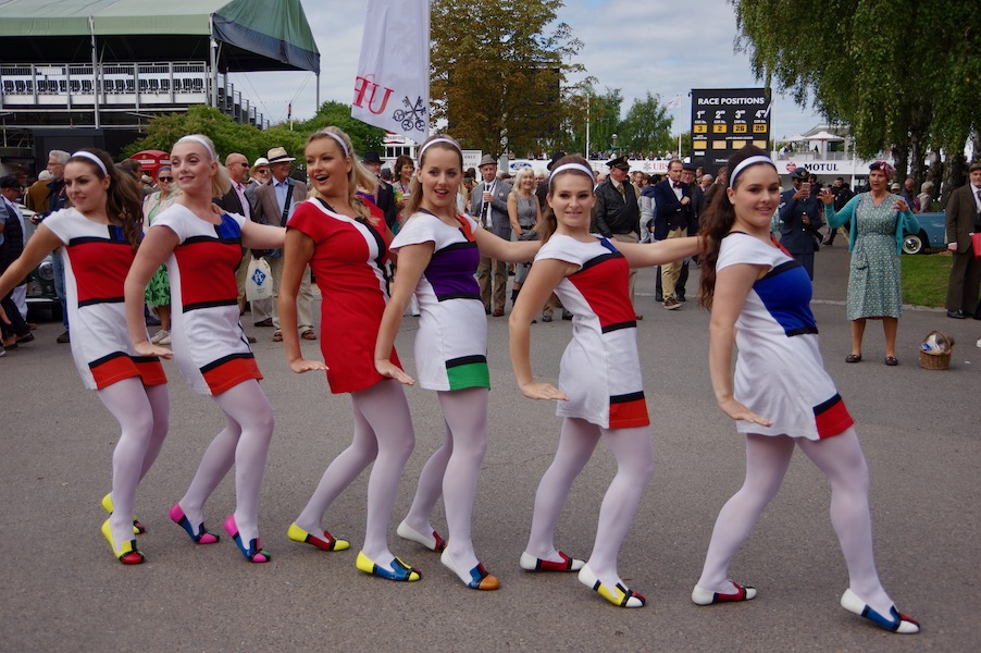 A group of young women in Mary Quant Mondrian dresses perform a dance routine at the 2019 Goodwood Revival festival. Quant died April 13 at the age of 93. Image courtesy of Wikimedia Commons, photo credit David Merrett of Daventry, England. Shared under the Creative Commons Attribution 2.0 Generic license.