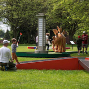 Family playing the Bertoia Bronze hole at Cranbrook on the Green, Summer 2022. Image courtesy of Cranbrook Art Museum, photo credit PD Rearick.
