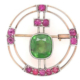 Circa-1900 pin with large demantoid garnet and ruby accents, estimated at $20,000-$24,000