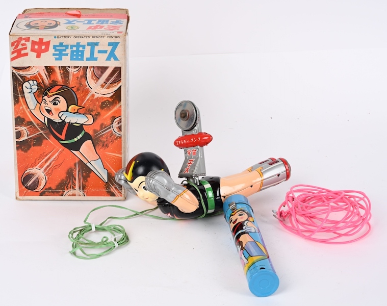 Bandai (Japan) battery-operated Flying Space Ace. All original and complete with colorfully decorated remote control and wire track for toy to fly on. Accompanied by original Japanese-language box. Very rare. Estimate $3,000-$5,000