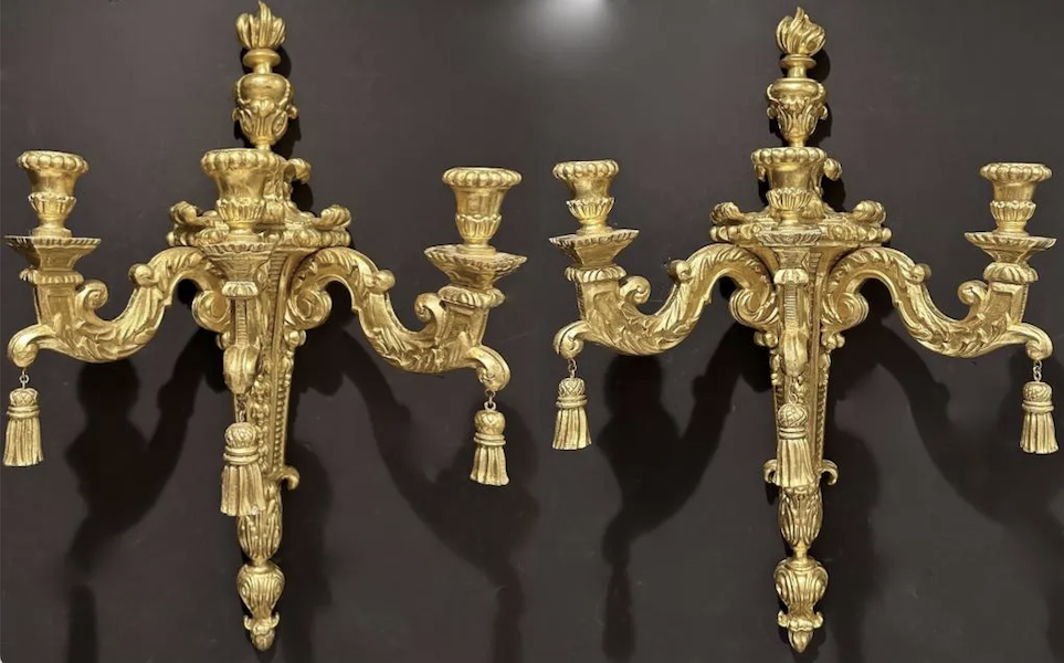 Pair of large carved gilt-wood Louis XVI wall sconces, three-arm style, not electrified. Each 36in x 15in x 20in. Estimate $800-$1,200 the pair