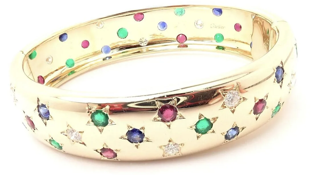 Cartier 18K gold, diamond, ruby, emerald and sapphire Star bangle bracelet, estimated at $28,000-$34,000