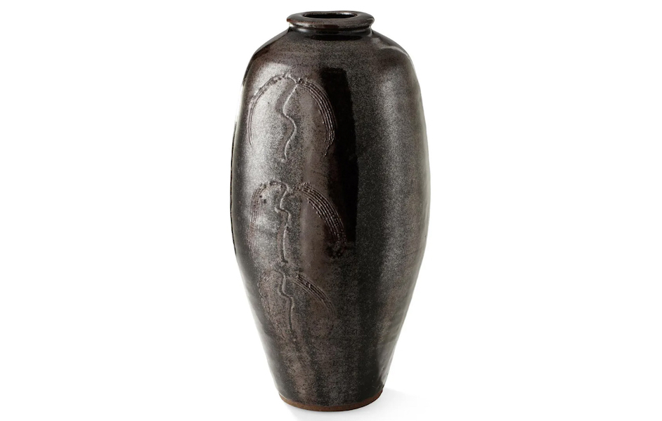 A vase by British studio ceramicist Bernard Leach with an incised willow tree design in a tenmoku glaze sold for $5,281 plus the buyer’s premium in October 2021. Image courtesy of Lyon & Turnbull and LiveAuctioneers.
