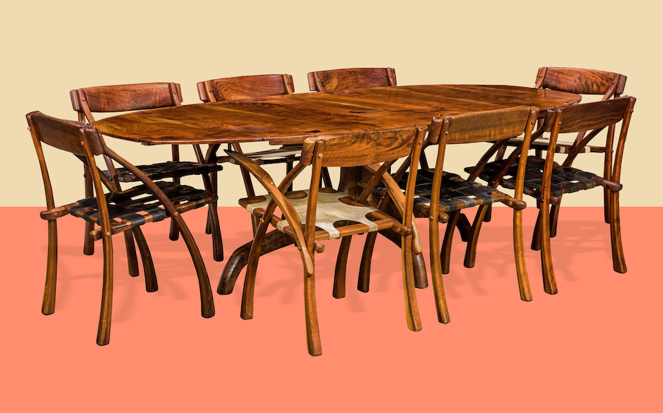 Suite of eight Arthur Espenet Carpenter Wishbone chairs, estimated at $20,000-$40,000, shown surrounding an Arthur Espenet Carpenter dining table with five butterfly inlays, estimated at $10,000-$15,000. Image courtesy of Clars Auction Gallery