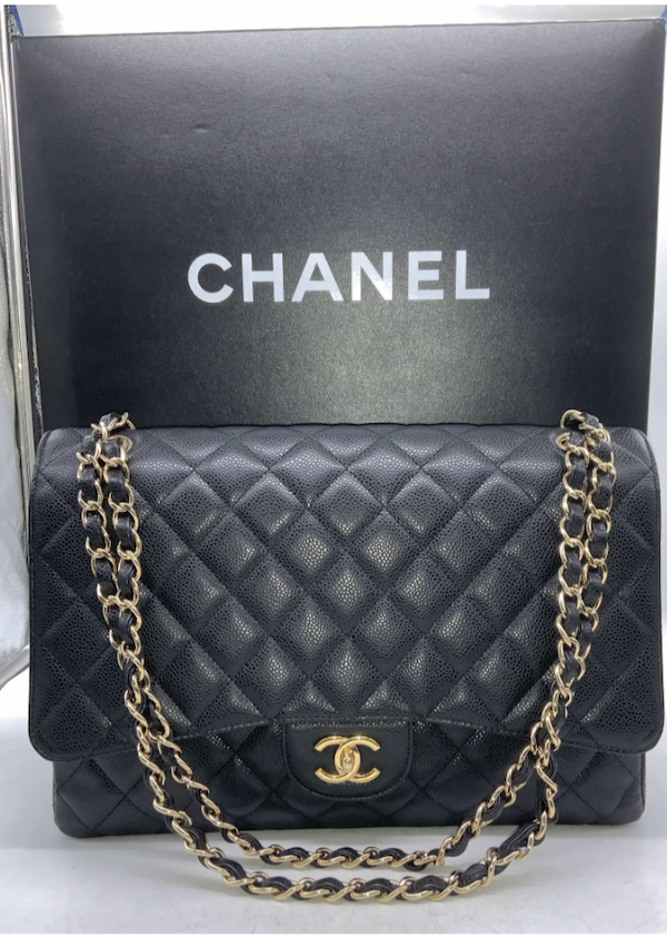 Chanel caviar black leather maxi classic handbag with its original Chanel box, estimated at $200-$2,000 