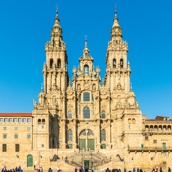 Exterior of the Santiago de Compostela cathedral in Galicia, Spain, photographed in July 2021. It is among the many iconic churches and religious buildings in Europe that have struggled to remain functional as sites of worship while also welcoming tourists. Image courtesy of Wikimedia Commons, photo credit Fernando. Shared under the Creative Commons Attribution-Share Alike 4.0 International license.