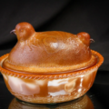 Greentown McKee chocolate glass two-headed chick dish, estimated at $2,500-$4,500 at Magnum Auctions.