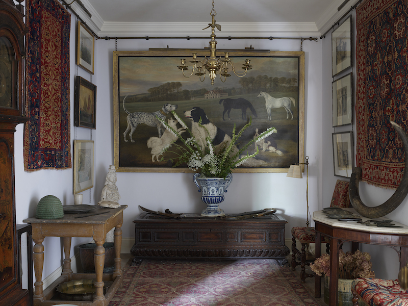 Hallway in the Warwick Square, London home of interior designer Robert Kime. Image courtesy of Dreweatts, photo credit Simon Upton, flowers by Hannah Kime