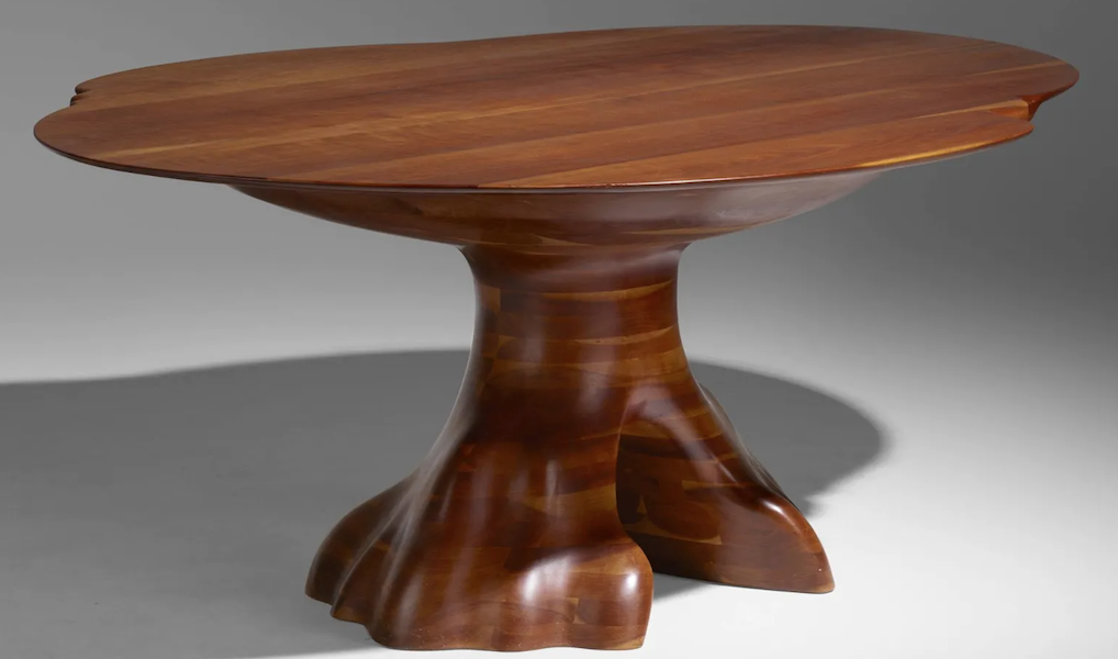 A Wendell Castle custom cherry dining table from 1976 realized $125,000 plus the buyer’s premium in May 2022. Image courtesy of Rago Arts and Auction Center and LiveAuctioneers.