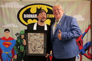 Consignor Kevin Smith (left) and auction house owner Joe Bodnar (right) pose with the top lot from the September 27 sale, a page of original comic book art from Daredevil issue 161, which sold for $67,500 ($79,650 with buyer’s premium). Image courtesy of Bodnar’s Auction Sales.