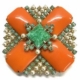 Signed Schreiner green and orange art glass brooch, estimated at $100-$250 at the Benefit Shop Foundation.