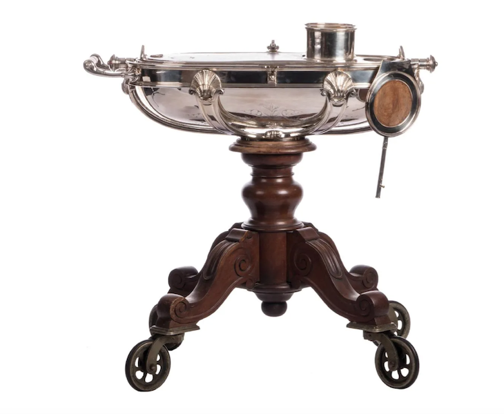 A Christofle rechaud/bain marie de salle (water bath) silver piece on a mahogany base, dating to the second half of the 19th century, realized €8,800 ($8,682) plus the buyer’s premium in March 2017. Image courtesy of Carlo Bonte Auctions and LiveAuctioneers.
