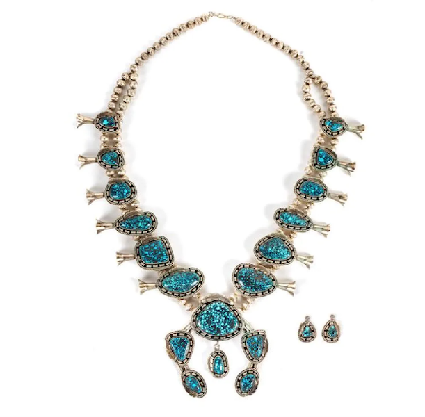 A silver squash blossom necklace sporting 12 blossoms, each with a single high-grade spiderweb turquoise stone and offered with a pair of earrings, realized $13,000 plus the buyer’s premium in May 2019. Image courtesy of Hindman and LiveAuctioneers.