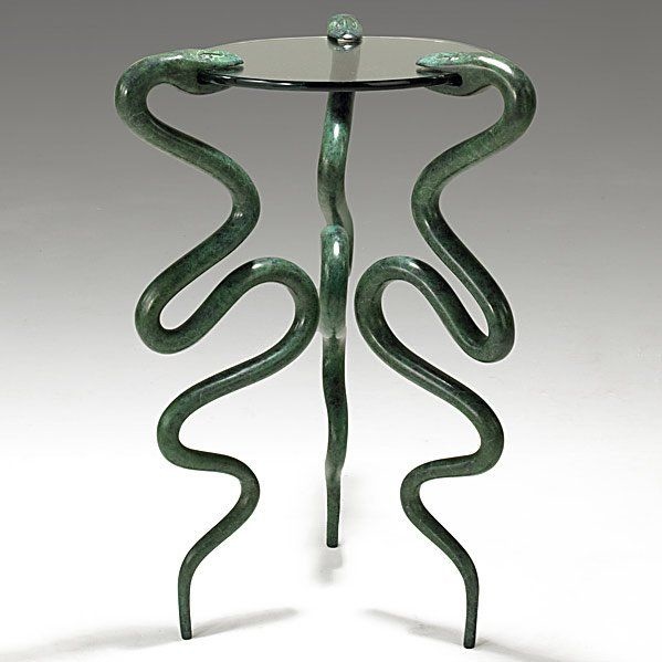 A trio of snakes forms the legs of Judy Kensley McKie’s 1997 Serpent side table. All three snakes are engraved ‘JKM 97.’ It is numbered 15 of 16. It sold for $26,000 + the buyer’s premium in 2010. Image courtesy of Rago Arts and Auction Center and LiveAuctioneers