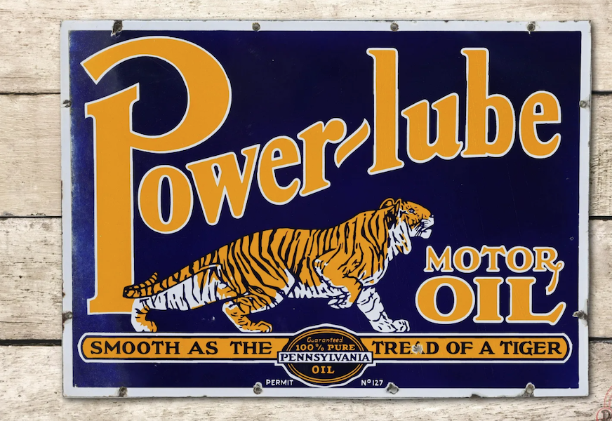 A Power-Lube Motor Oil double-sided porcelain sign depicting a tiger secured $10,000 plus the buyer’s premium in August 2022. Image courtesy of Richmond Auctions and LiveAuctioneers.