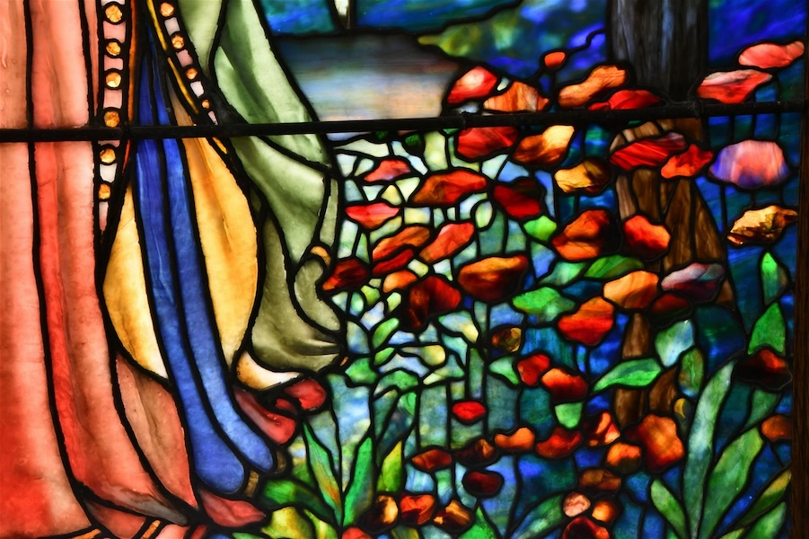Detail of a circa-1916 Tiffany Studios ‘Gabriel Blowing His Horn’ window, showing the artisans’ use of purplish blue and red glass in this instance. It made $85,000 plus the buyer’s premium in September 2021. Image courtesy of Fontaine’s Auction Gallery and LiveAuctioneers.