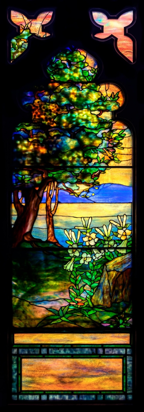 Tiffany Studios secular windows bring strong prices, such as this sunset landscape window from 1915 that earned $230,000 plus the buyer’s premium in March 2023. Image courtesy of Cottone Auctions and LiveAuctioneers.