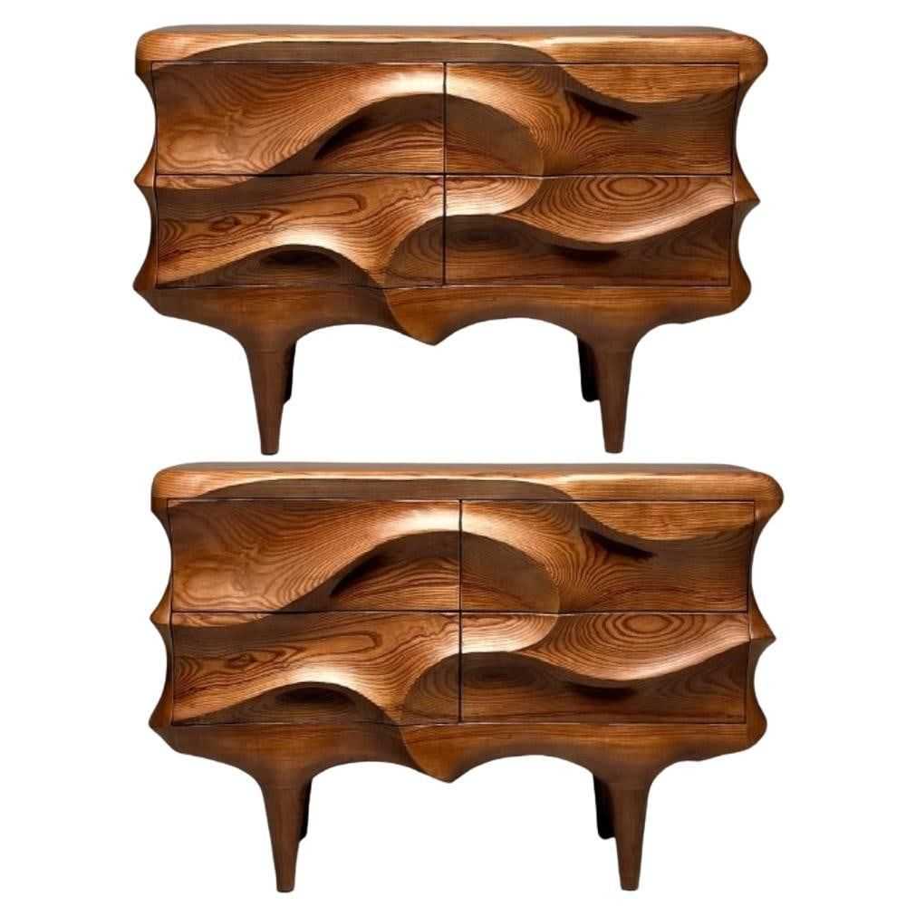 Contemporary pair of sculptural cabinets in ash wood with a stained walnut finish, estimated at $14,000-$17,000 at Jasper52.